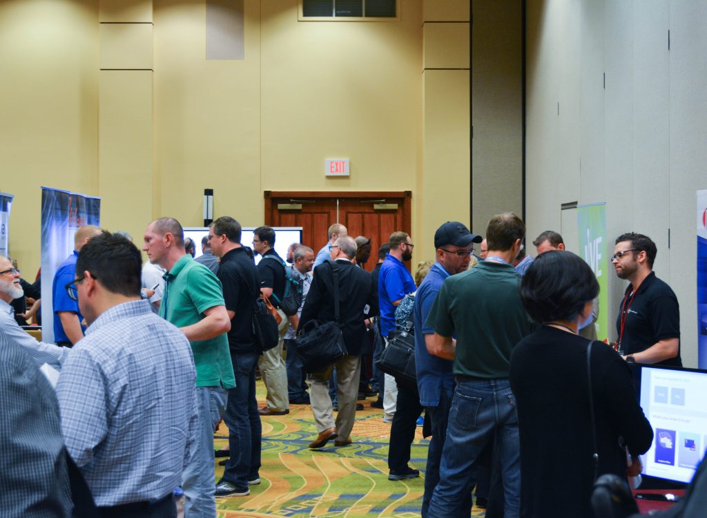 Summit attendees and vendors networking between sessions