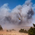 A helicopter flying over the Rhea Wildfire
